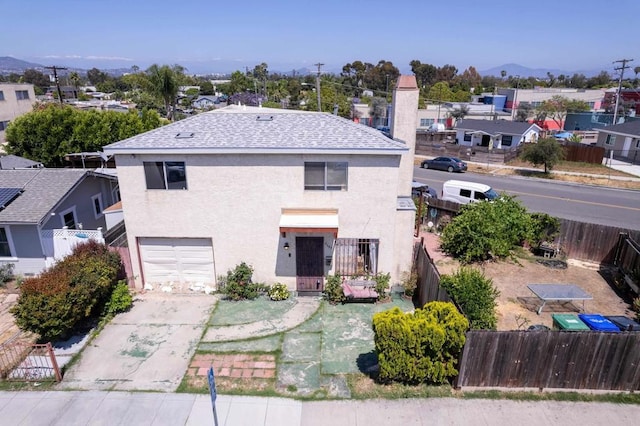 4643 Cherokee Ave, San Diego, CA 92116 - traditional-style home featuring an attached garage, stucco siding, driveway, roof with shingles, and a mountain view