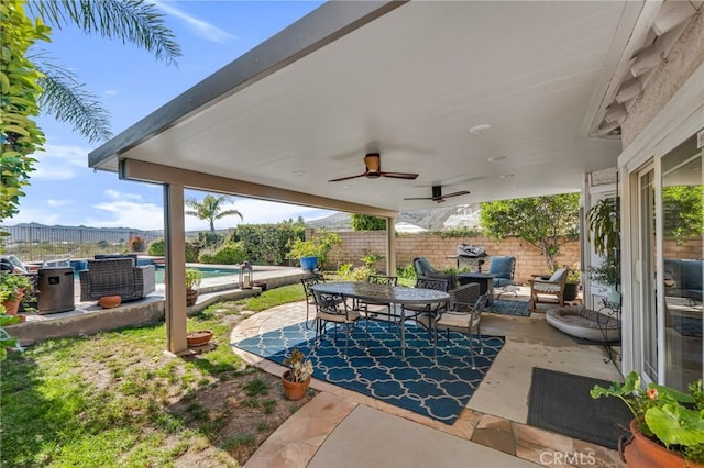 12045 Falcon Crest Way, Porter Ranch, CA 91326 - fenced backyard with a patio area, outdoor dining space, and a ceiling fan
