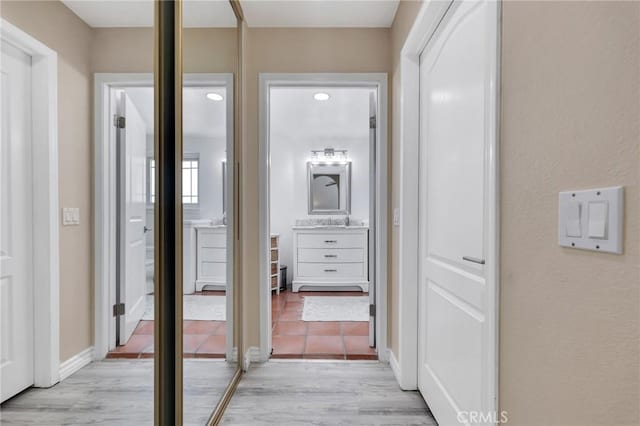 12045 Falcon Crest Way, Porter Ranch, CA 91326 - corridor featuring light wood-style flooring and baseboards