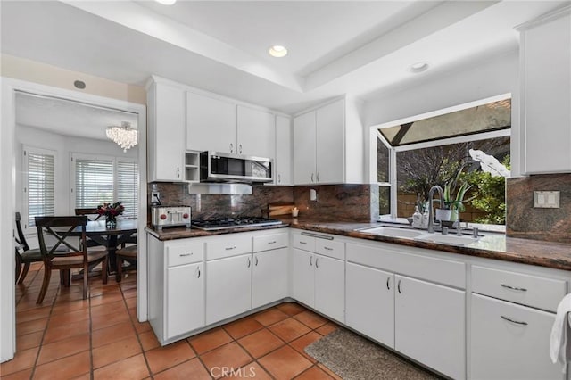 12045 Falcon Crest Way, Porter Ranch, CA 91326 - kitchen with appliances with stainless steel finishes, a sink, light tile patterned floors, tasteful backsplash, and recessed lighting