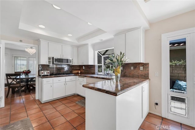 12045 Falcon Crest Way, Porter Ranch, CA 91326 - kitchen featuring appliances with stainless steel finishes, decorative backsplash, a raised ceiling, light tile patterned floors, and recessed lighting
