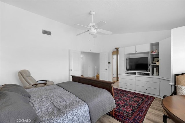 12045 Falcon Crest Way, Porter Ranch, CA 91326 - bedroom with light wood-style floors, vaulted ceiling, arched walkways, and a ceiling fan