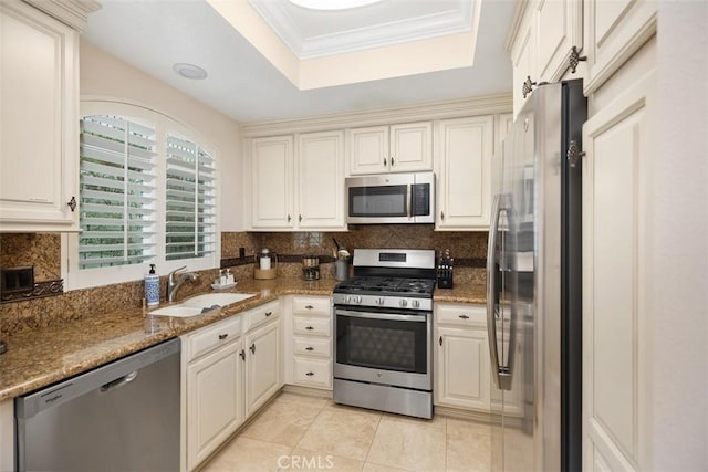 30902 Clubhouse Dr Unit 28C, Laguna Niguel, CA 92677 - kitchen featuring stainless steel appliances, a tray ceiling, light tile patterned flooring, backsplash, and stone countertops