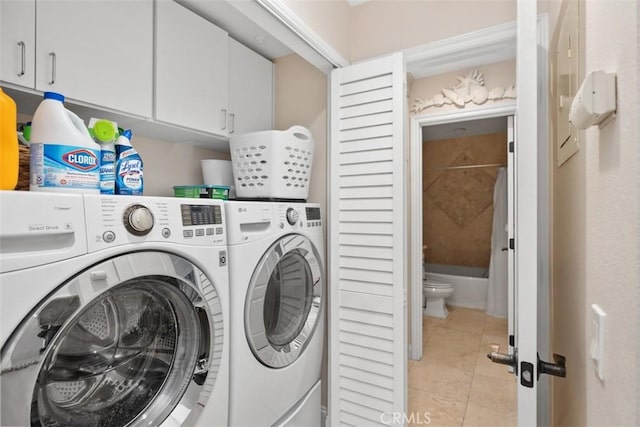 30902 Clubhouse Dr Unit 28C, Laguna Niguel, CA 92677 - laundry room with cabinet space, washer and dryer, and light tile patterned floors