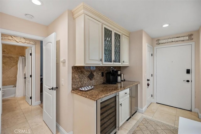 30902 Clubhouse Dr Unit 28C, Laguna Niguel, CA 92677 - kitchen featuring beverage cooler, light tile patterned flooring, baseboards, stone counters, and backsplash