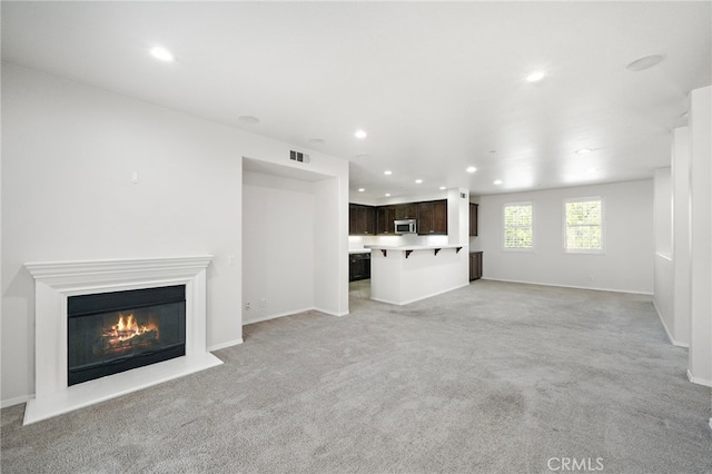 61 Silverado, Irvine, CA 92618 - unfurnished living room featuring recessed lighting, light colored carpet, and a glass covered fireplace