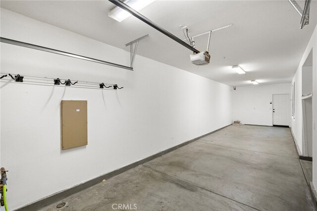 61 Silverado, Irvine, CA 92618 - garage featuring a garage door opener and baseboards