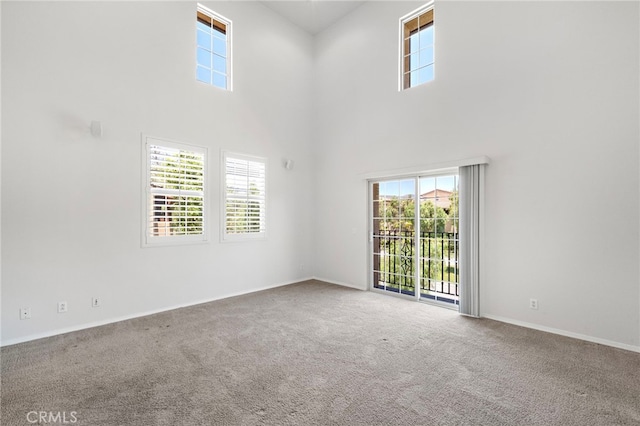 61 Silverado, Irvine, CA 92618 - empty room featuring a high ceiling, plenty of natural light, and carpet flooring
