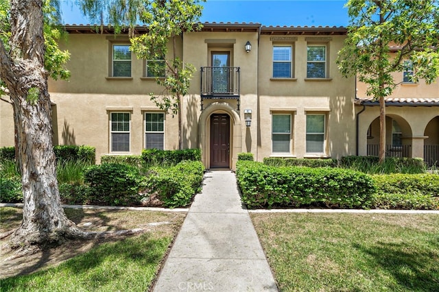 61 Silverado, Irvine, CA 92618 - view of front of house featuring a balcony and stucco siding