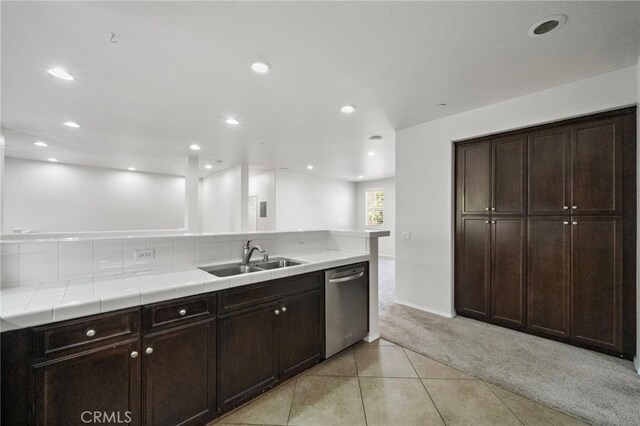 61 Silverado, Irvine, CA 92618 - kitchen featuring stainless steel dishwasher, light colored carpet, light tile patterned floors, recessed lighting, and dark brown cabinets