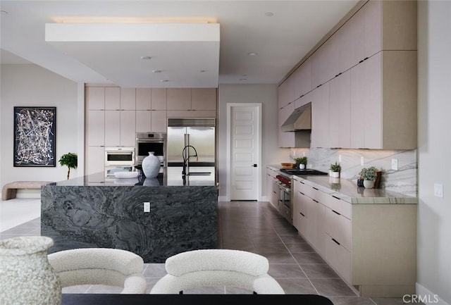 18510 Boulder Blf, Silverado, CA 92676 - kitchen with high quality appliances, under cabinet range hood, modern cabinets, and decorative backsplash