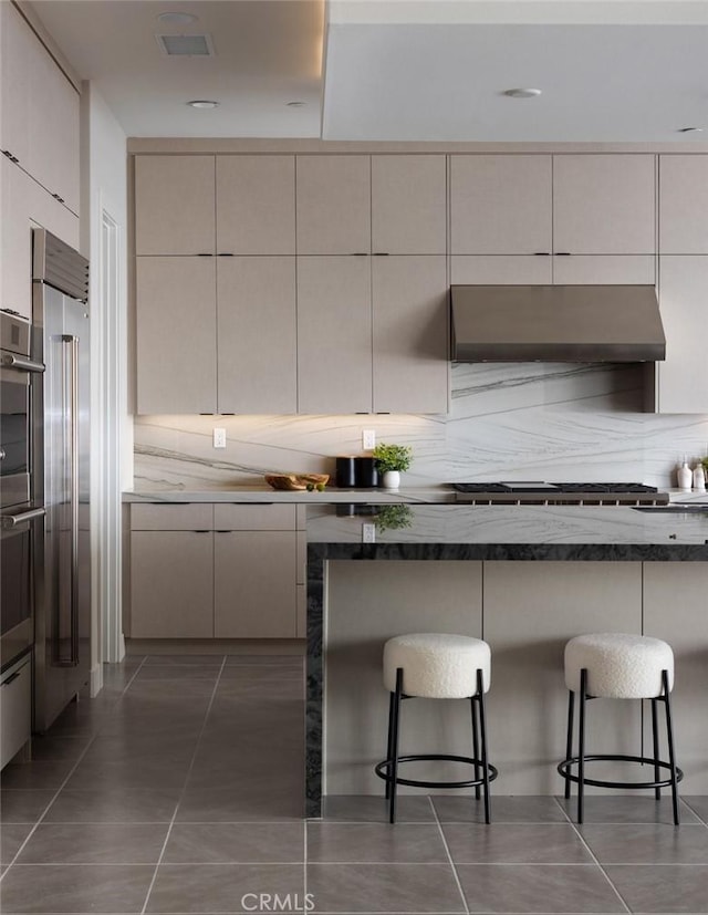 18510 Boulder Blf, Silverado, CA 92676 - kitchen with exhaust hood, a kitchen breakfast bar, and modern cabinets