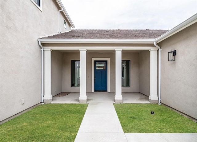 18510 Boulder Blf, Silverado, CA 92676 - view of exterior entry with stucco siding and a yard