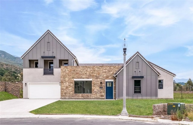 18510 Boulder Blf, Silverado, CA 92676 - modern inspired farmhouse featuring board and batten siding, an attached garage, driveway, stone siding, and a mountain view