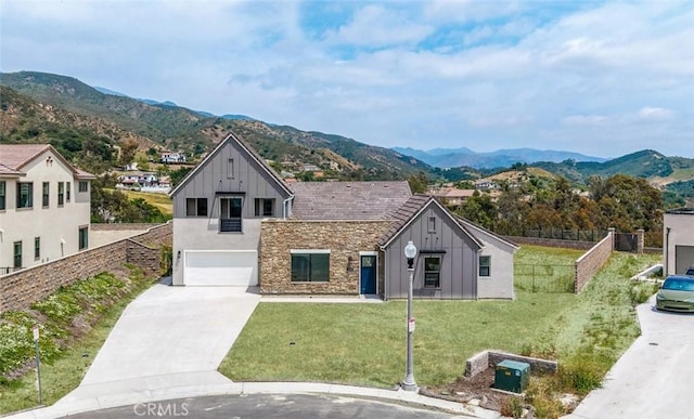 18510 Boulder Blf, Silverado, CA 92676 - view of front facade featuring board and batten siding, an attached garage, driveway, a mountain view, and stone siding