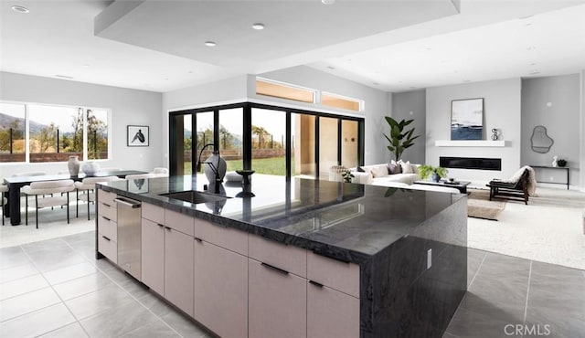 18510 Boulder Blf, Silverado, CA 92676 - kitchen with a sink, light tile patterned flooring, stainless steel dishwasher, dark stone counters, and a large island