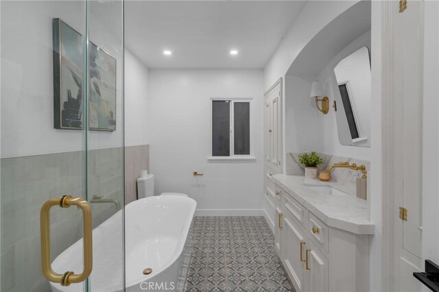 3649 Mount Vernon Dr, View Park, CA 90008 - full bathroom featuring vanity, a soaking tub, recessed lighting, baseboards, and tile patterned floors