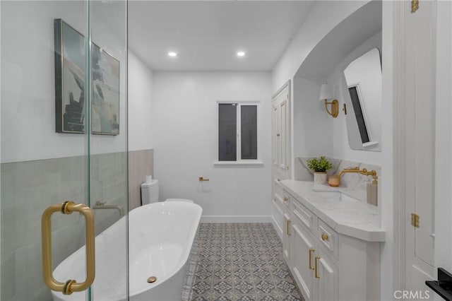 3649 Mount Vernon Dr, View Park, CA 90008 - bathroom featuring vanity, a freestanding bath, recessed lighting, and tile patterned floors