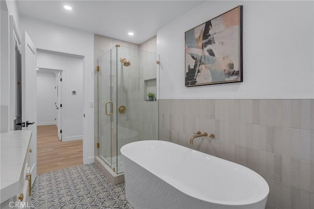 3649 Mount Vernon Dr, View Park, CA 90008 - full bathroom featuring a soaking tub, a stall shower, tile walls, recessed lighting, and vanity