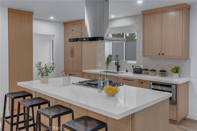 3649 Mount Vernon Dr, View Park, CA 90008 - kitchen with island exhaust hood, light brown cabinetry, a sink, appliances with stainless steel finishes, and a kitchen breakfast bar