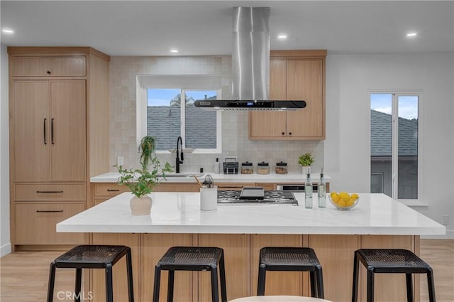 3649 Mount Vernon Dr, View Park, CA 90008 - kitchen featuring island range hood, light brown cabinetry, a sink, light wood-type flooring, and recessed lighting
