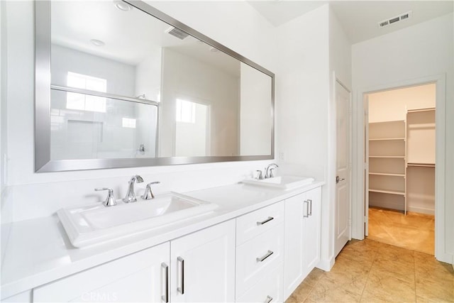 12392 Sandy Ct, Whittier, CA 90602 - bathroom with a shower with shower door, double vanity, a walk in closet, and tile patterned flooring