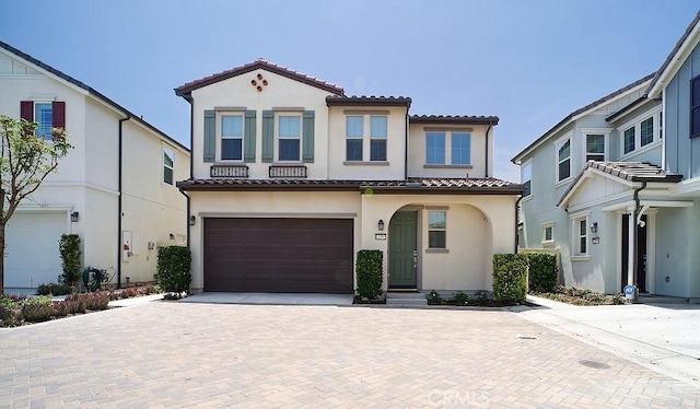 12392 Sandy Ct, Whittier, CA 90602 - mediterranean / spanish house with a tile roof, a garage, decorative driveway, and stucco siding