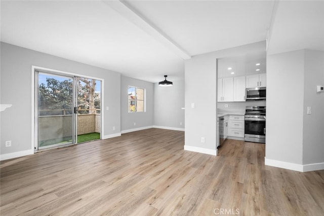 645 Chestnut Ave Unit 202, Long Beach, CA 90802 - unfurnished living room with light wood-style flooring and baseboards