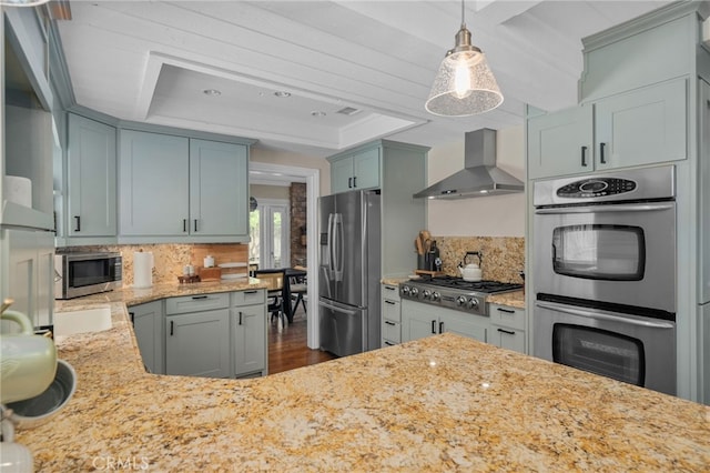 732 Hilary Ln, Redlands, CA 92373 - kitchen with wall chimney exhaust hood, appliances with stainless steel finishes, a raised ceiling, and decorative backsplash