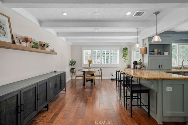 732 Hilary Ln, Redlands, CA 92373 - kitchen with open shelves, dark wood-style floors, light stone countertops, a kitchen breakfast bar, and wooden ceiling with exposed beams
