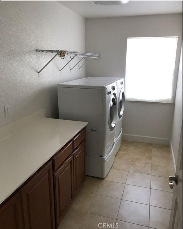 639 Burnt Ranch Way, Chico, CA 95973 - laundry room featuring washing machine and clothes dryer, light tile patterned flooring, and cabinet space