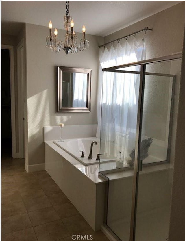 639 Burnt Ranch Way, Chico, CA 95973 - bathroom featuring a chandelier, a bath, a stall shower, and tile patterned flooring