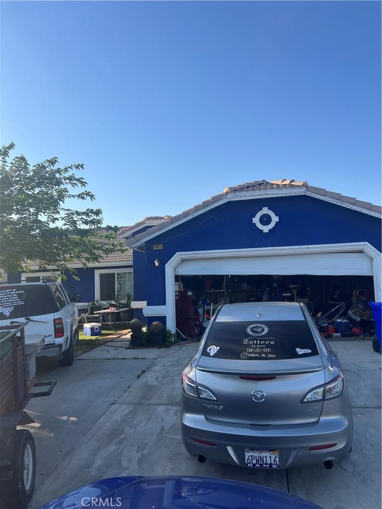 10430 Butte St, Adelanto, CA 92301 - view of parking / parking lot featuring concrete driveway and an attached garage