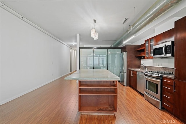 1111 S Grand Ave Unit 702, Los Angeles, CA 90015 - kitchen with open shelves, stainless steel appliances, modern cabinets, and light wood finished floors