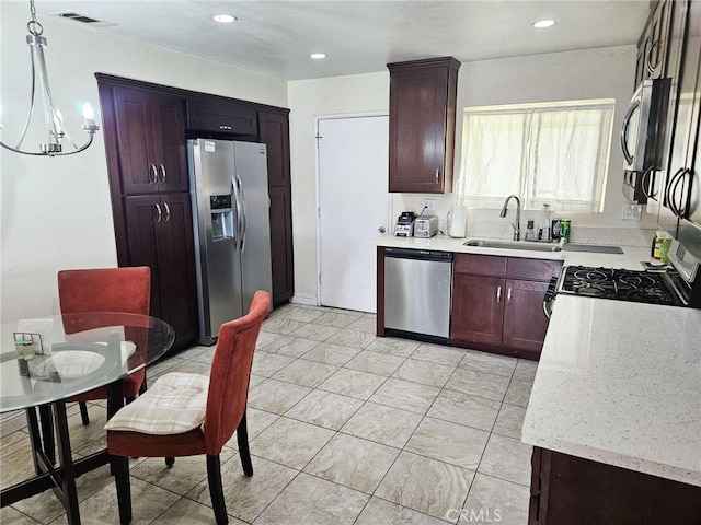 7121 Lion St, Rancho Cucamonga, CA 91701 - kitchen with stainless steel appliances, a sink, light stone countertops, recessed lighting, and dark brown cabinetry