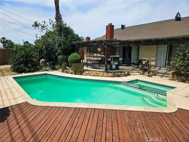 7121 Lion St, Rancho Cucamonga, CA 91701 - view of swimming pool featuring a pergola, a wooden deck, a pool with connected hot tub, and a patio area