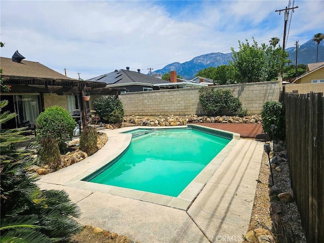 7121 Lion St, Rancho Cucamonga, CA 91701 - view of pool with a mountain view, a fenced backyard, and a pool with connected hot tub