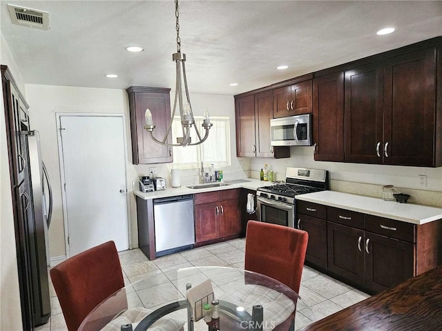 7121 Lion St, Rancho Cucamonga, CA 91701 - kitchen featuring appliances with stainless steel finishes, a chandelier, light countertops, pendant lighting, and recessed lighting