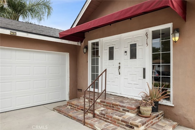 6515 Amigo Ave, Reseda, CA 91335 - property entrance with stucco siding, an attached garage, and a shingled roof