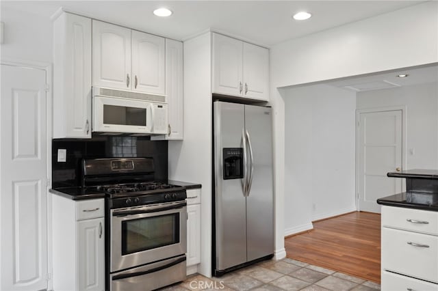 6515 Amigo Ave, Reseda, CA 91335 - kitchen featuring appliances with stainless steel finishes, dark countertops, white cabinetry, tasteful backsplash, and recessed lighting