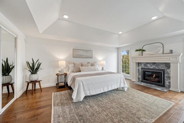 233 Elaine Way, Pismo Beach, CA 93449 - bedroom with wood finished floors, a tray ceiling, a premium fireplace, and recessed lighting