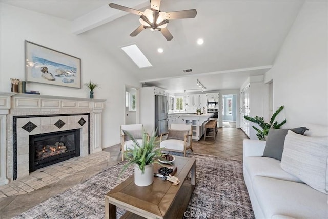 233 Elaine Way, Pismo Beach, CA 93449 - living room featuring healthy amount of natural light, ceiling fan, a fireplace, recessed lighting, and a skylight