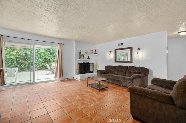 510 Archibald Ct, Colton, CA 92324 - living area featuring light tile patterned flooring, a textured ceiling, and a fireplace with raised hearth