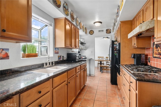 510 Archibald Ct, Colton, CA 92324 - kitchen with stainless steel gas stovetop, a sink, a ceiling fan, under cabinet range hood, and light tile patterned flooring