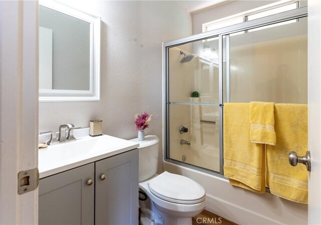 25717 Leah Ln, Menifee, CA 92586 - bathroom with vanity, shower / bath combination with glass door, and toilet