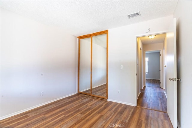 25717 Leah Ln, Menifee, CA 92586 - unfurnished bedroom featuring wood finished floors, a closet, baseboards, and a textured ceiling