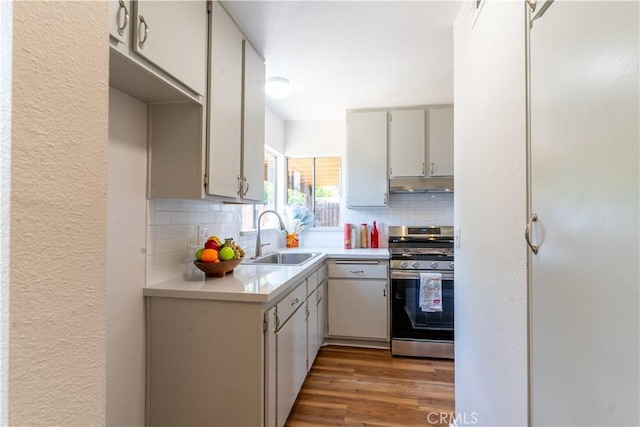 25717 Leah Ln, Menifee, CA 92586 - kitchen featuring stainless steel gas range, a sink, light countertops, white dishwasher, and under cabinet range hood