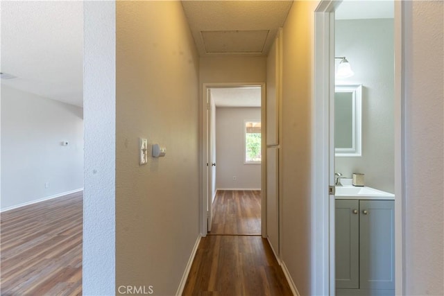 25717 Leah Ln, Menifee, CA 92586 - corridor featuring dark wood-style flooring, a sink, and baseboards