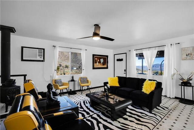 49490 Big Morongo Canyon Rd, Morongo Valley, CA 92256 - living area with a ceiling fan, a wood stove, and baseboards