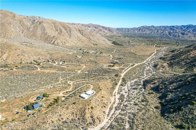 49490 Big Morongo Canyon Rd, Morongo Valley, CA 92256 - aerial overview of property's location featuring a mountain backdrop, rural landscape, and a desert landscape